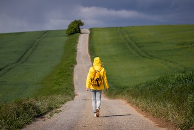Woman walking down a road